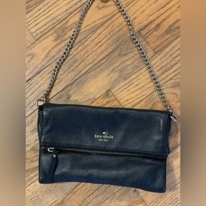 Black Kate Spade clutch, chain strap, zipper closure and magnetic closure.